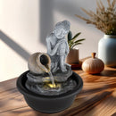 Fontana da interno Buddha con acqua in movimento luce calda LED e base nera decorativa effetto pietra