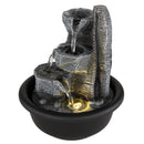 Fontana da interno decorativa con effetto pietra grigia base nera e acqua illuminata da luce calda