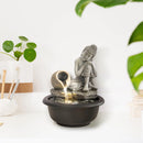 Fontana zen con Buddha luce calda e movimento acqua per atmosfera armoniosa in casa o ufficio
