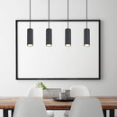 Lampadario tubolare nero sopra tavolo da pranzo con design moderno e luci regolabili in altezza