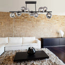 plafoniera moderna in metallo nero con bolle in vetro fumè ideale sopra tavolo da pranzo