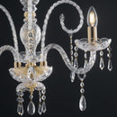 Lampadario barocco trasparente con bracci in vetro riccioli decorativi piattelli lavorati e finitura dorata